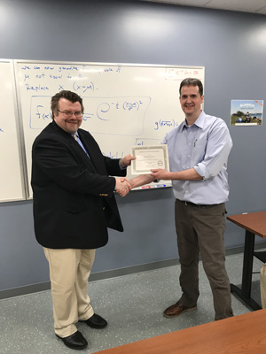 Paul Felker presents certificate to Nathaniel Brown